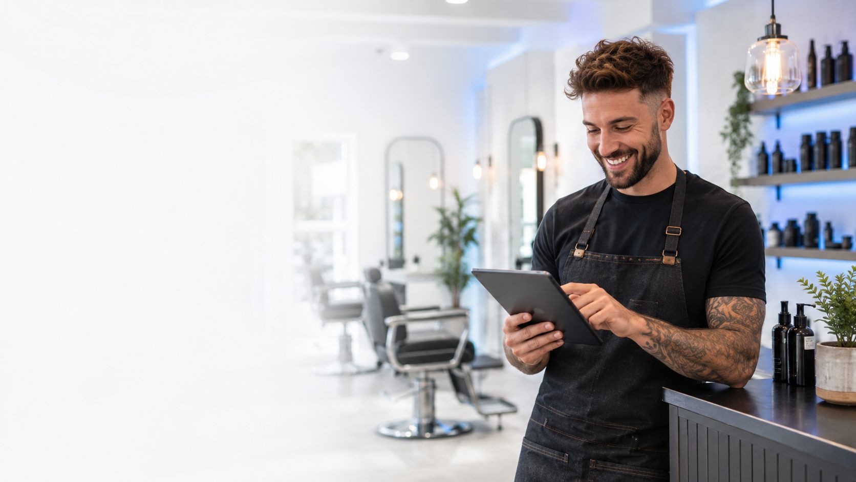 Salon owner using a tablet to manage bookings and customer messages